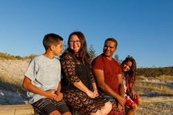 four people sitting in the wild