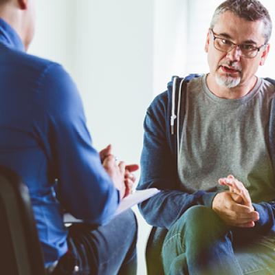 Photograph of two men talking